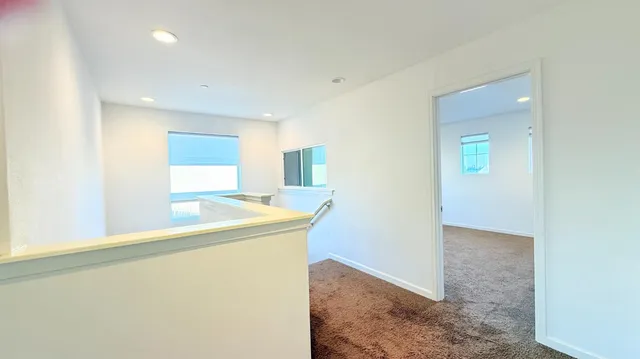 a view of a kitchen with a sink and a refrigerator
