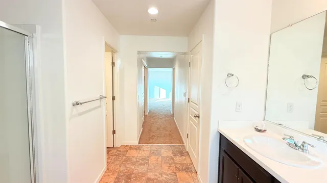 a view of a hallway with wooden floor