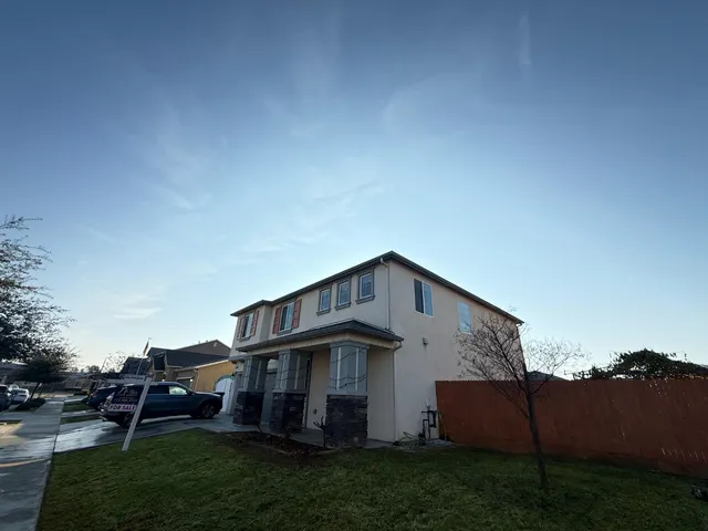 a backyard of a house with lots of green space and garden