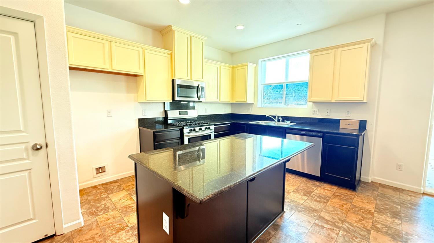 3935 East Myrtle Avenue Visalia, CA 93292 - Photo 4 of 41 a kitchen with stainless steel appliances granite countertop a sink a counter top space and cabinets