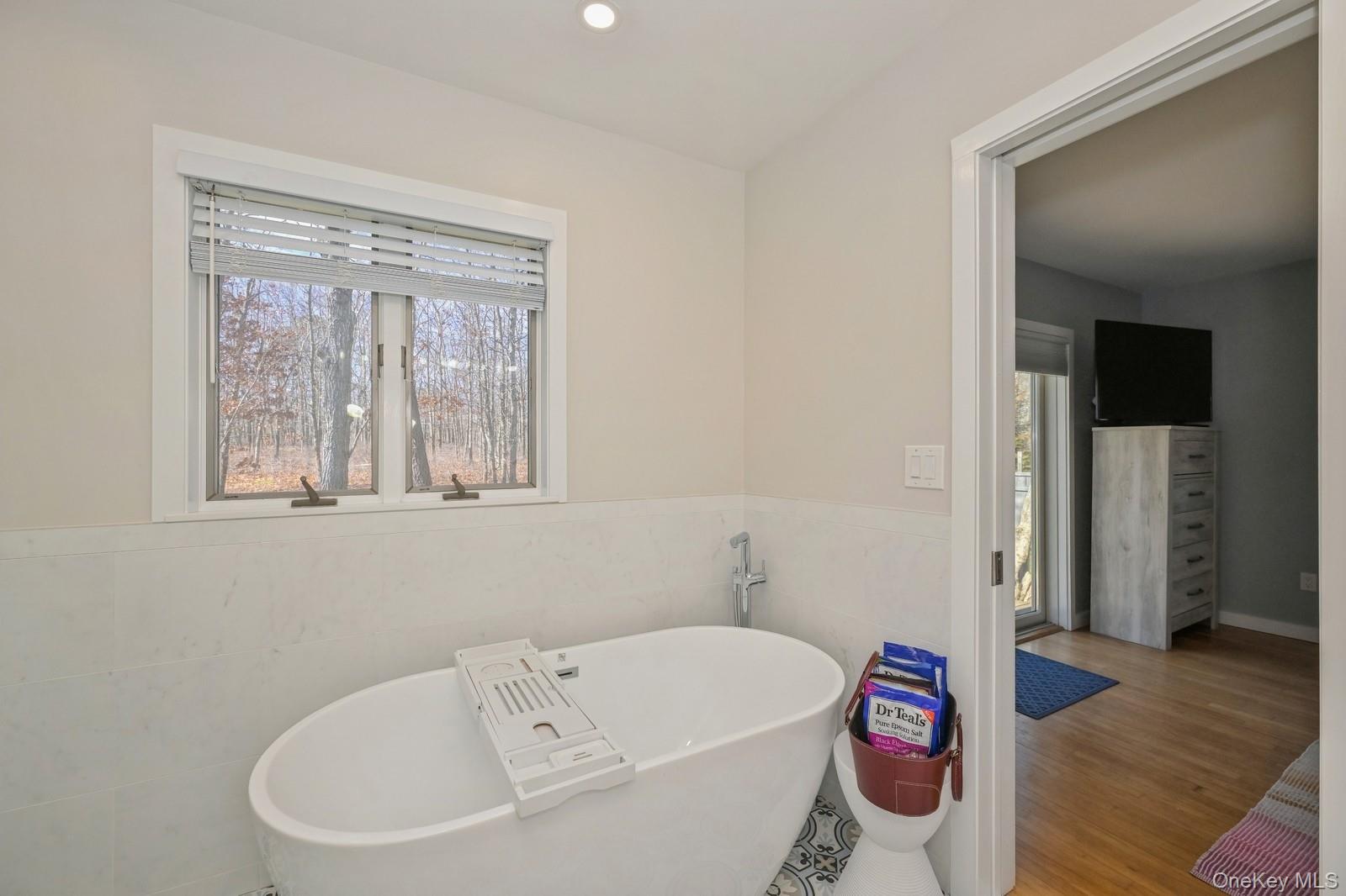 16 Hildreth Road Hampton Bays, NY 11946 - Photo 22 of 29 a white bath tub sitting next to a white toilet