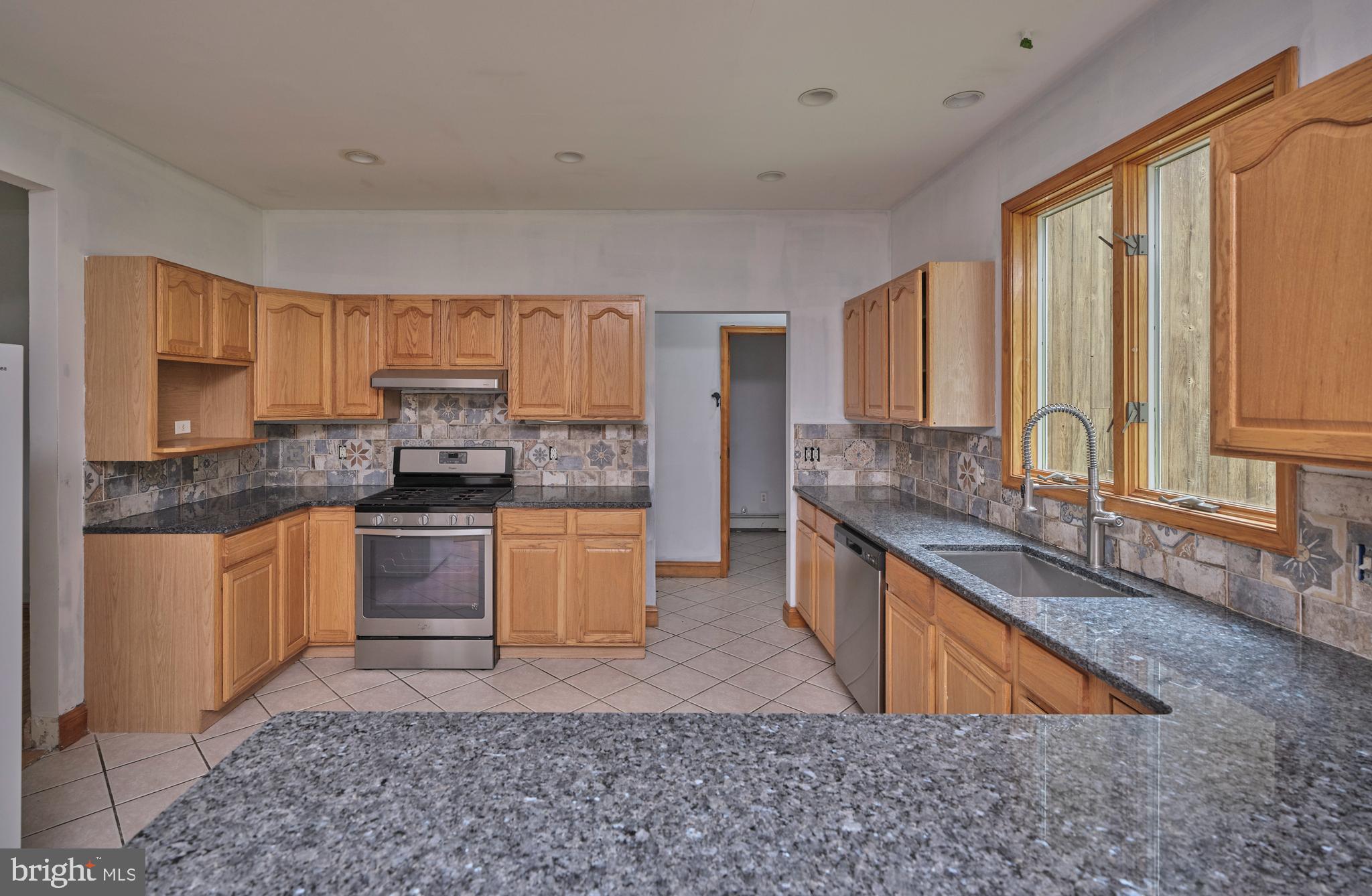 130 Rattlesnake Road Kintnersville, PA 18930 - Photo 7 of 29 a kitchen with stainless steel appliances granite countertop a sink stove and cabinets