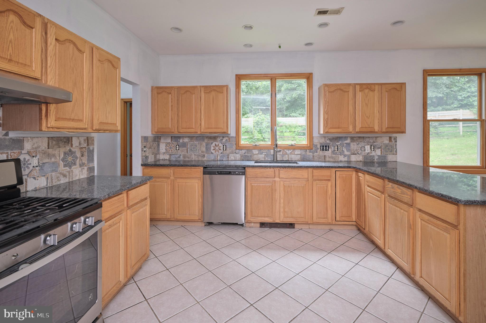 130 Rattlesnake Road Kintnersville, PA 18930 - Photo 8 of 29 a kitchen with stainless steel appliances granite countertop a stove a sink and a granite counter tops
