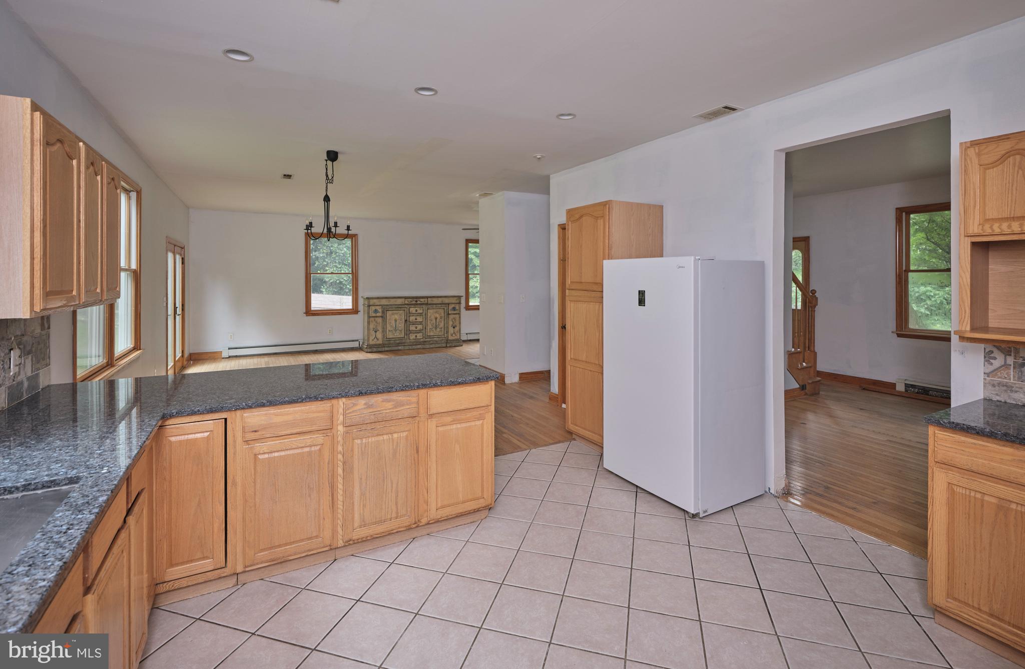 130 Rattlesnake Road Kintnersville, PA 18930 - Photo 9 of 29 a large kitchen with cabinets and wooden floor