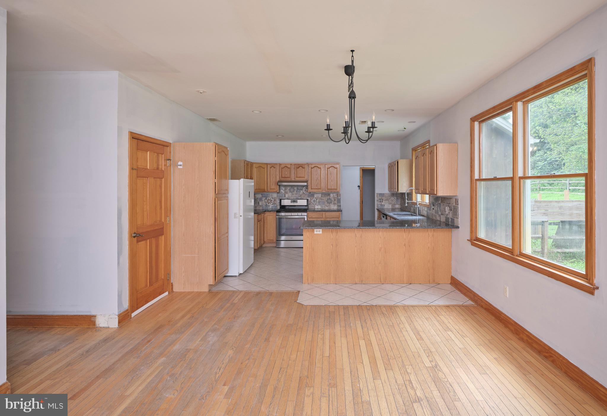 130 Rattlesnake Road Kintnersville, PA 18930 - Photo 10 of 29 a view of a living room and kitchen with wooden floor