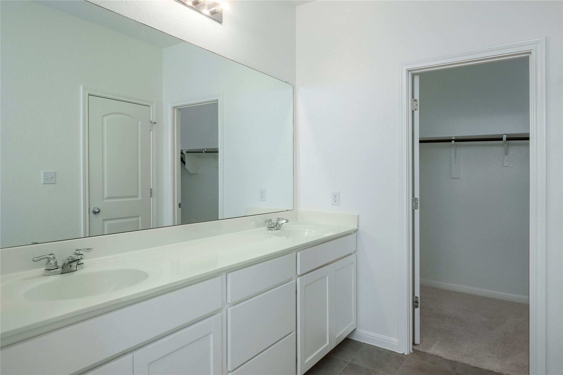 2540 Acoma Lane Leander, TX 78641 - Photo 18 of 26 a bathroom with a double vanity sink and a mirror