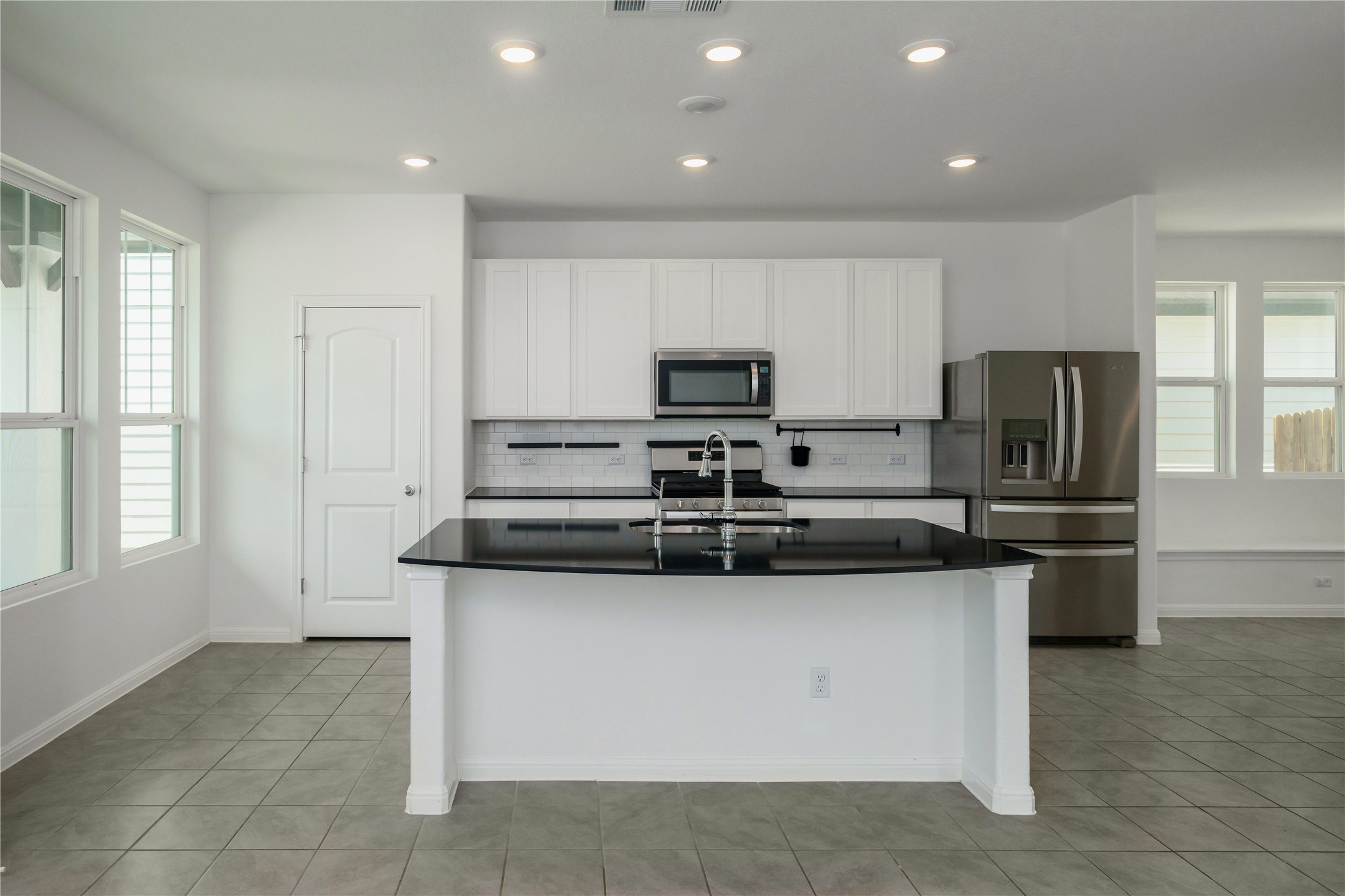 2540 Acoma Lane Leander, TX 78641 - Photo 2 of 26 a kitchen with stainless steel appliances granite countertop a stove a sink and a refrigerator