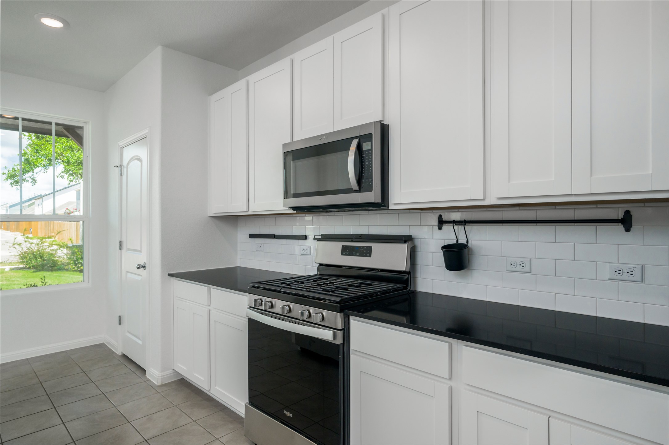 2540 Acoma Lane Leander, TX 78641 - Photo 6 of 26 a kitchen with granite countertop white cabinets and appliances