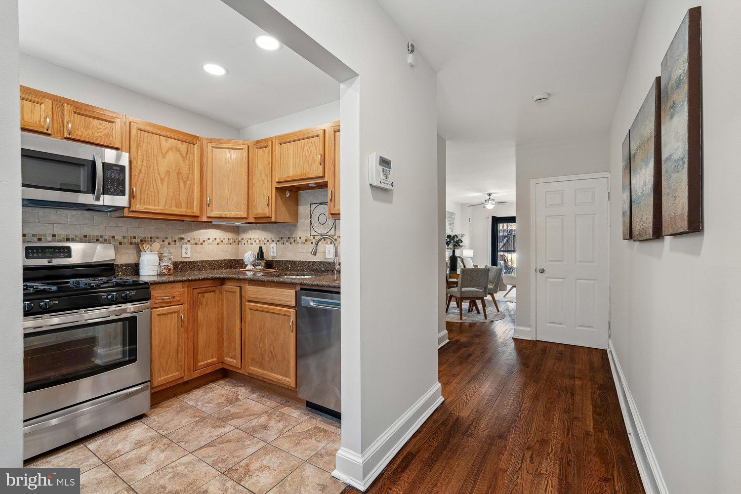 1652 Kramer Street Northeast Washington, DC 20002 - Photo 3 of 26 a kitchen with stainless steel appliances granite countertop a stove top oven a sink and a refrigerator