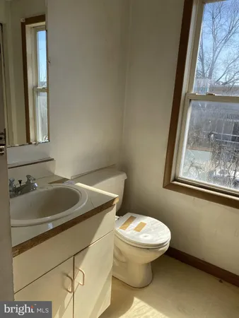 a bathroom with a sink and mirror with toilet