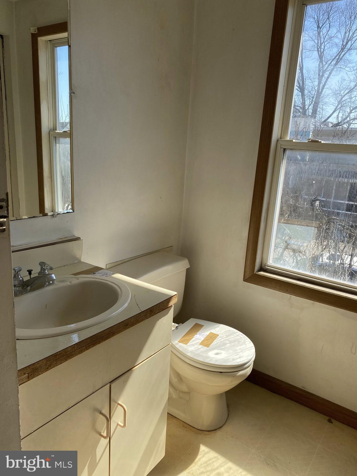 2502 Huron Street Baltimore, MD 21230 - Photo 2 of 14 a bathroom with a sink and mirror with toilet