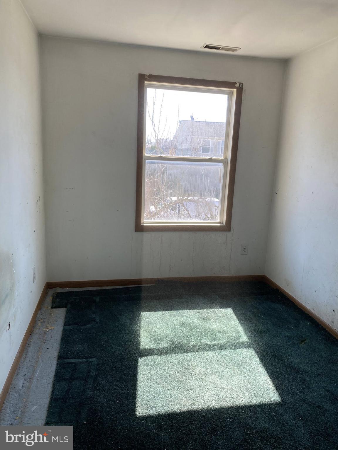 2502 Huron Street Baltimore, MD 21230 - Photo 4 of 14 an empty room with wooden floor and window