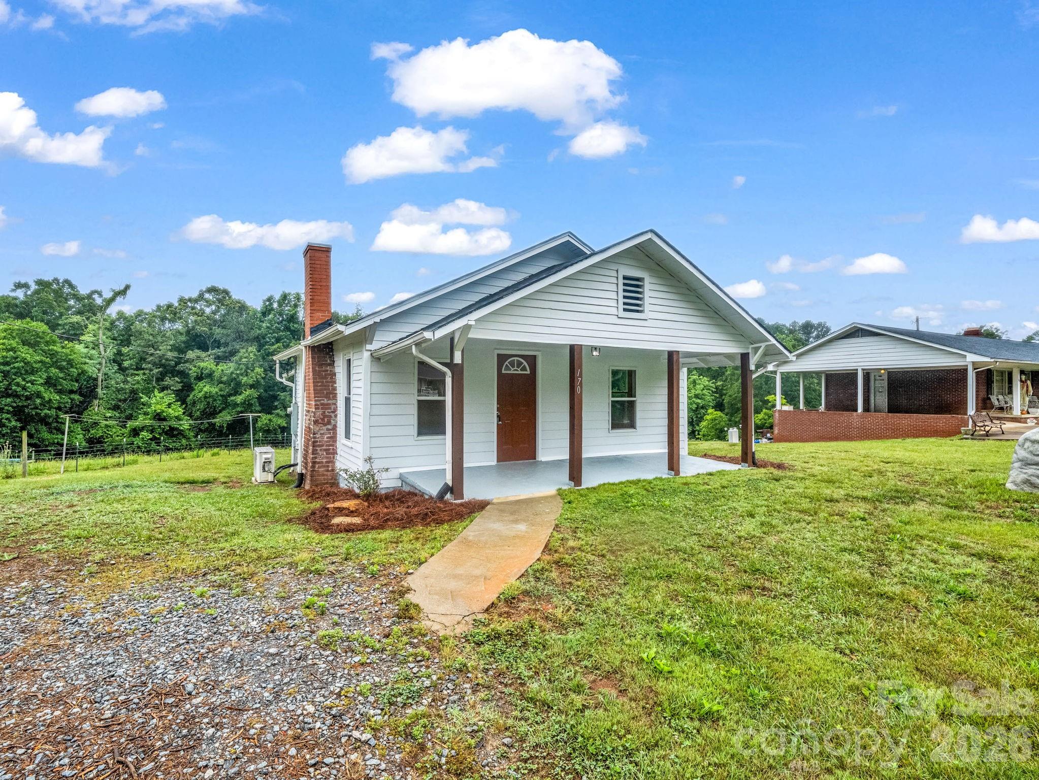 170 Dobbins Road Ellenboro, NC 28040 - Photo 3 of 32 a front view of a house with a garden
