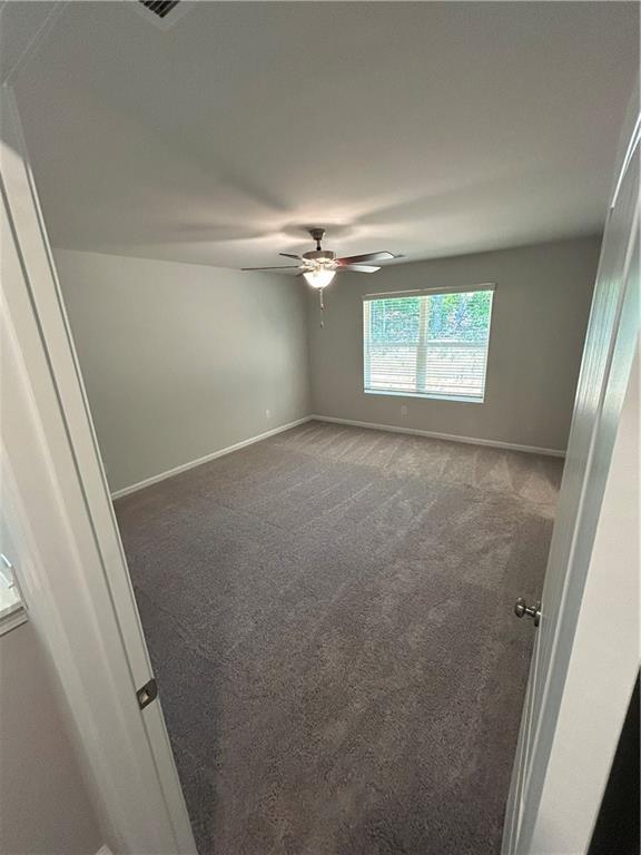27 Stonebrook Drive Rome, GA 30165 - Photo 16 of 22 an empty room with a ceiling fan and a window
