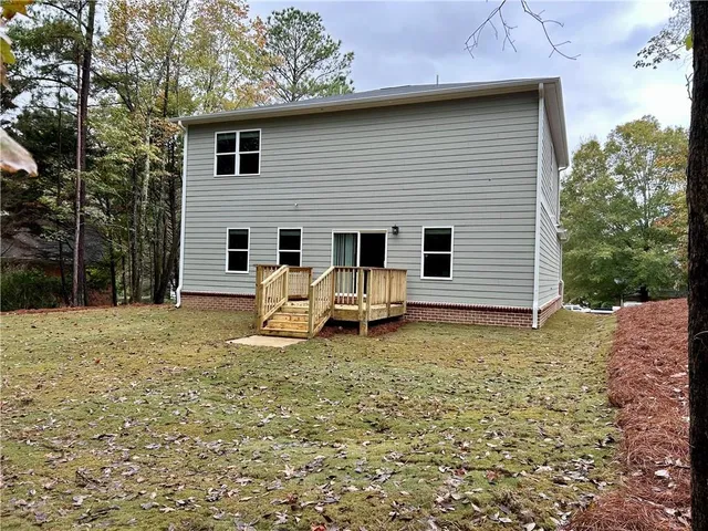 a backyard of a house with table and chairs