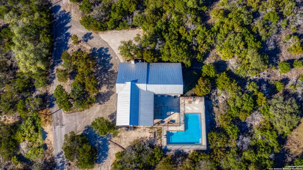 an aerial view of a house with a yard and garden
