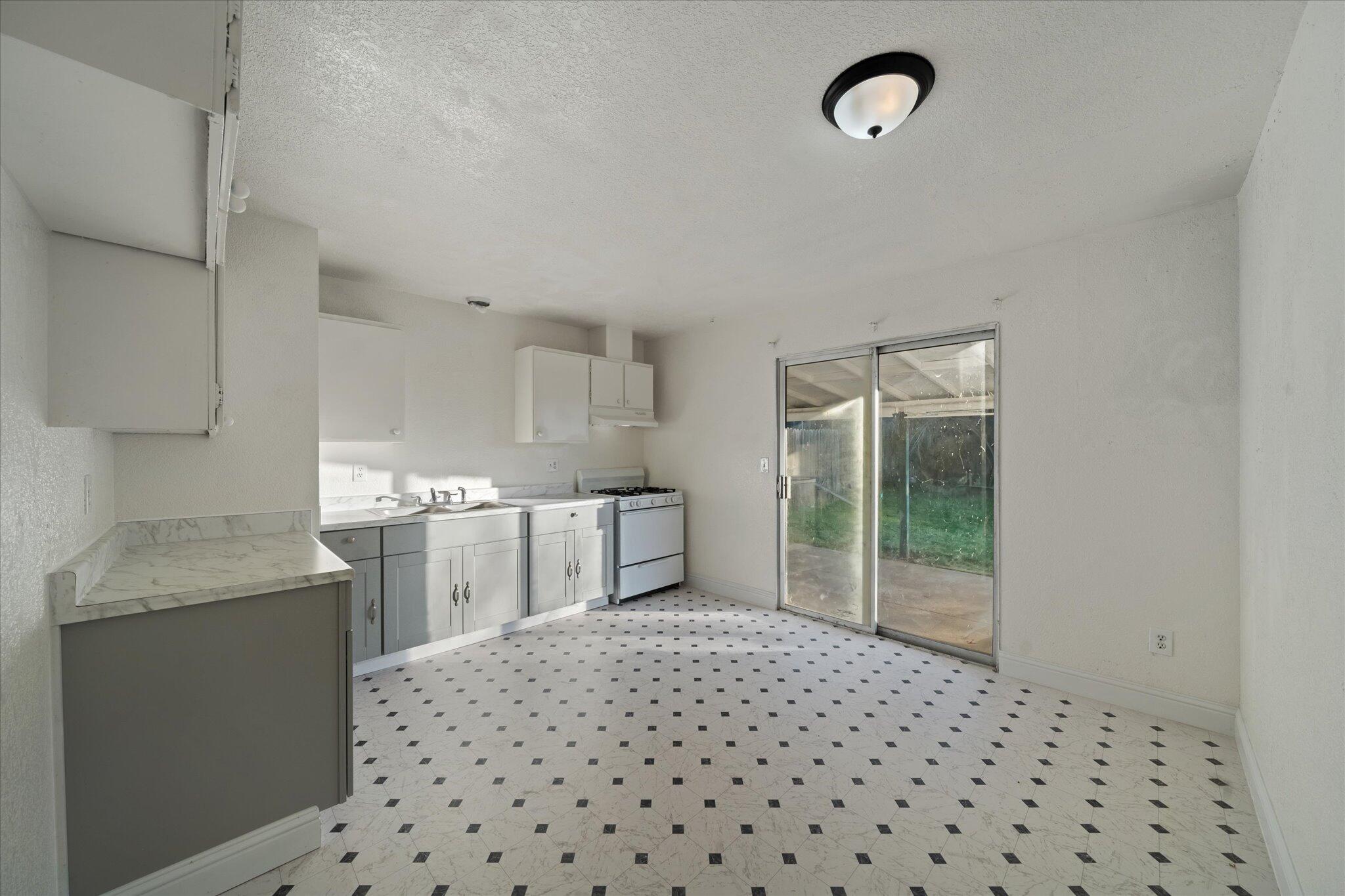 1994 Spruce Circle Anderson, CA 96007 - Photo 5 of 16 a kitchen with granite countertop a stove a sink and a granite counter tops