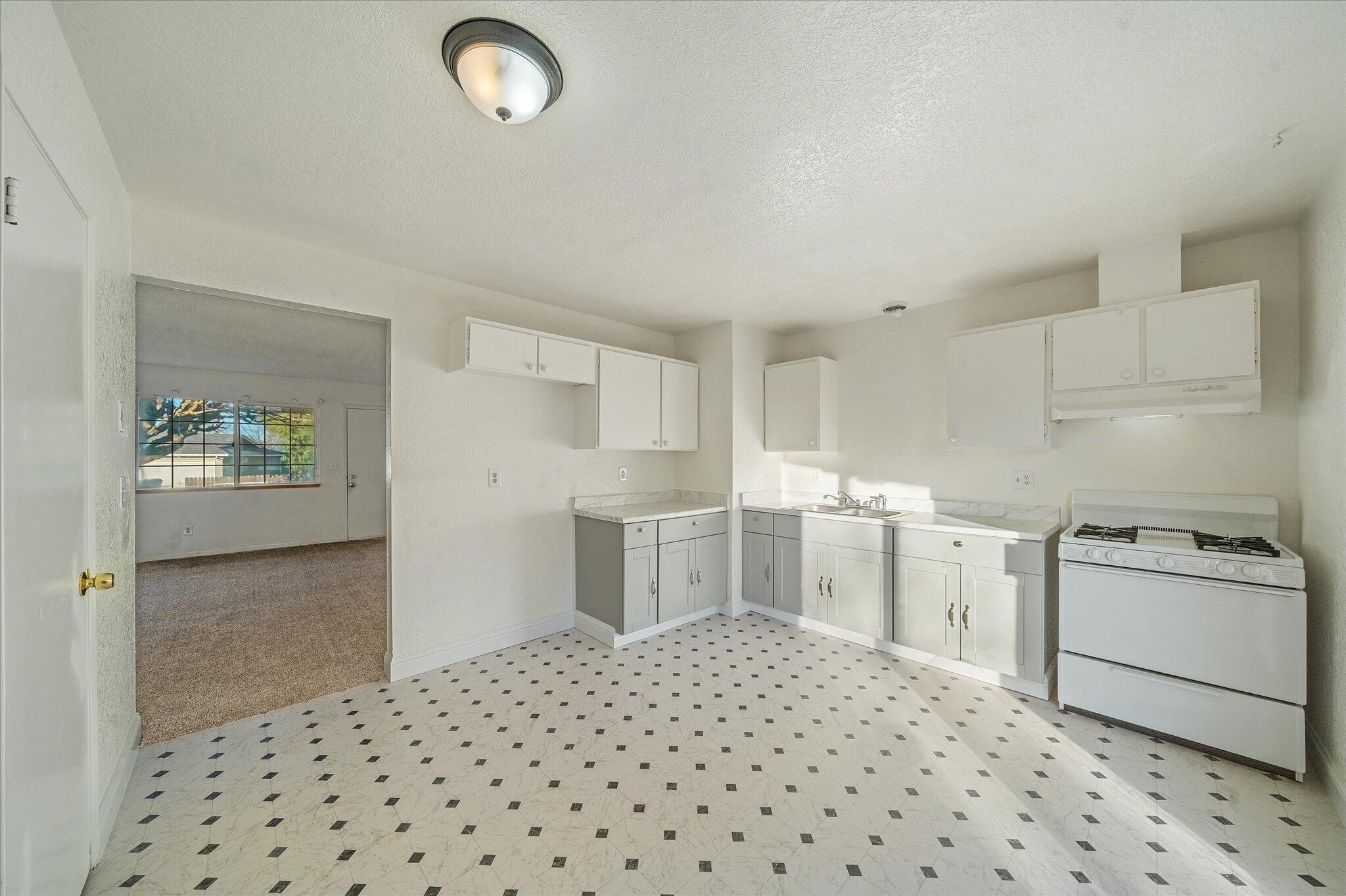 1994 Spruce Circle Anderson, CA 96007 - Photo 6 of 16 a kitchen with a sink a stove and cabinets