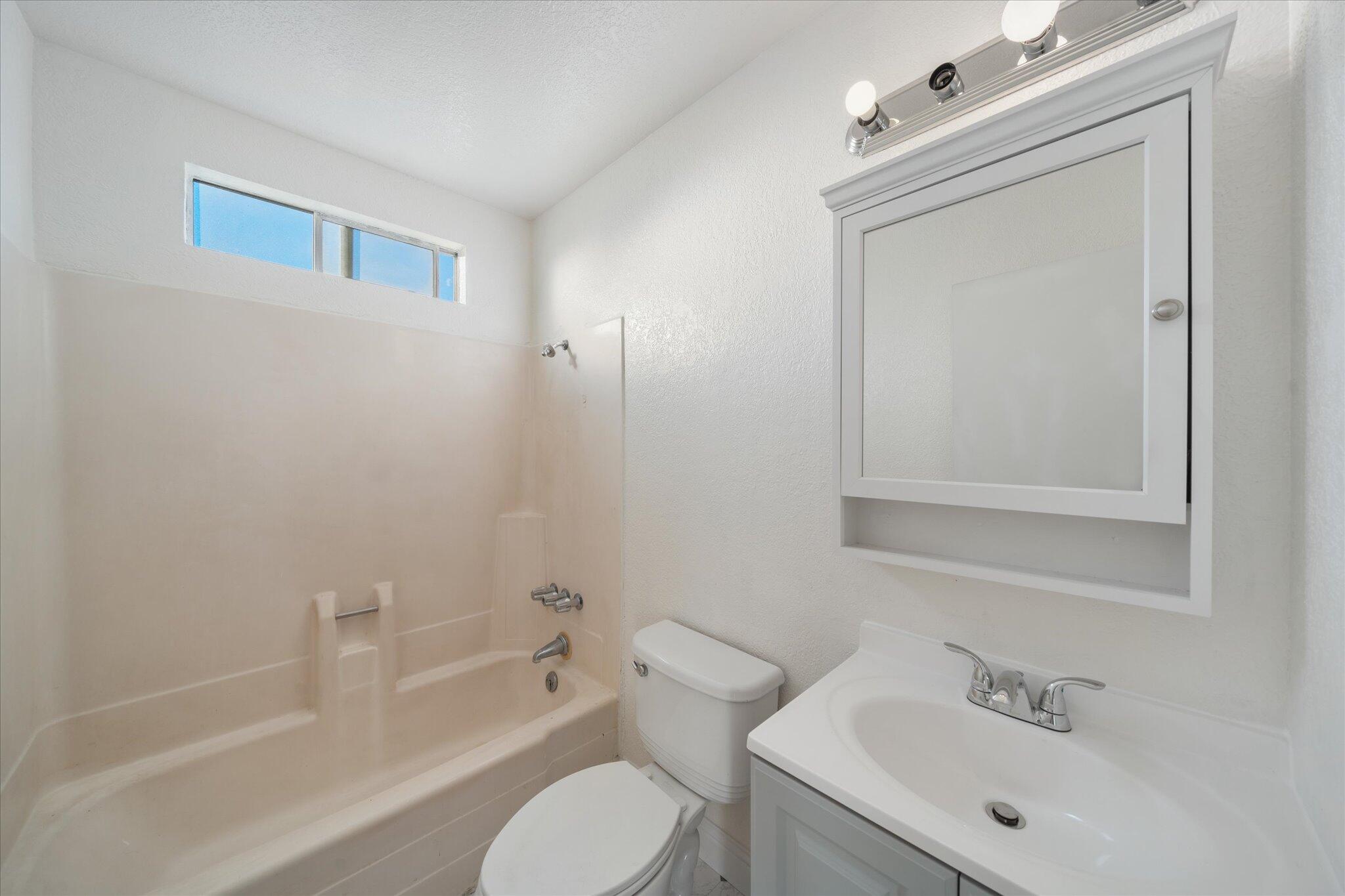 1994 Spruce Circle Anderson, CA 96007 - Photo 10 of 16 a bathroom with a sink mirror toilet and bathtub