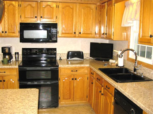 42 J Davis Road Charlton, MA 01507 - Photo 11 of 30 a kitchen with a stove and a microwave