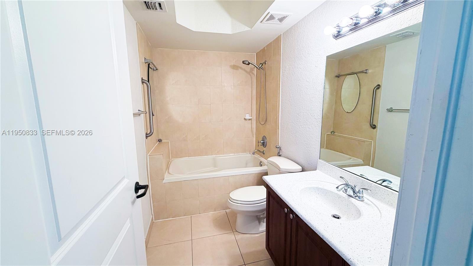 2301 Southwest 27th Avenue, Unit 1200 Miami, FL 33145 - Photo 17 of 24 a bathroom with a sink a toilet and shower
