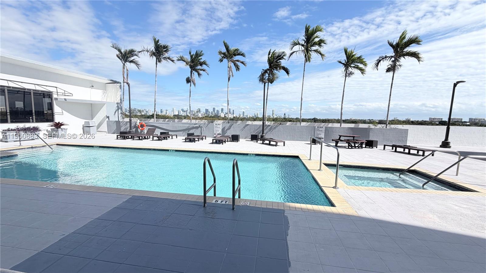 2301 Southwest 27th Avenue, Unit 1200 Miami, FL 33145 - Photo 20 of 24 a view of a swimming pool with a table and chairs