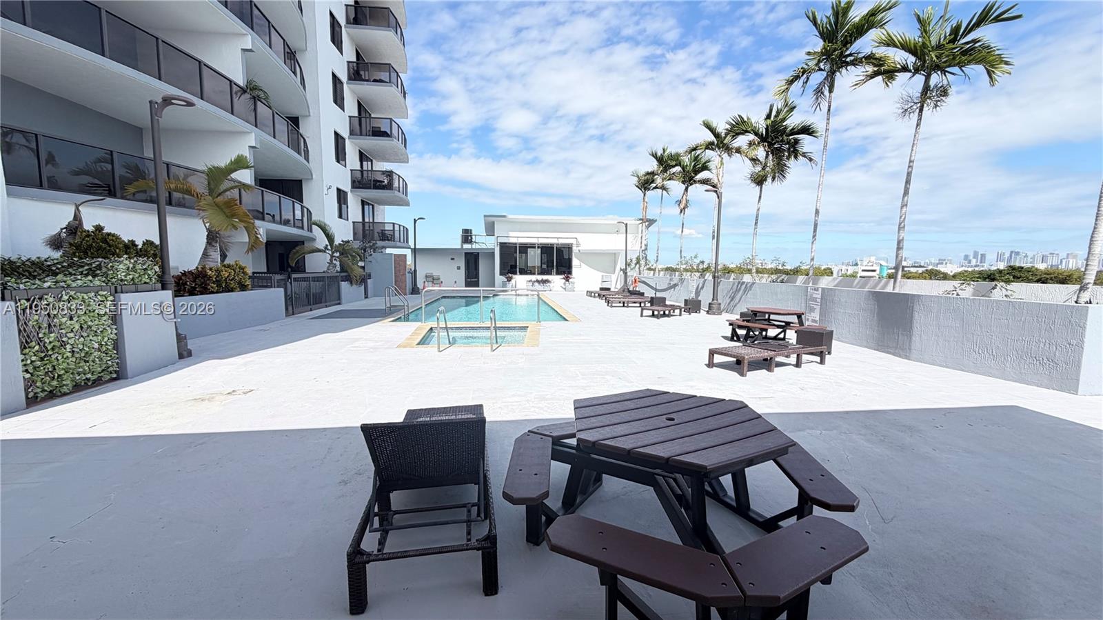 2301 Southwest 27th Avenue, Unit 1200 Miami, FL 33145 - Photo 21 of 24 a swimming pool with outdoor seating and yard