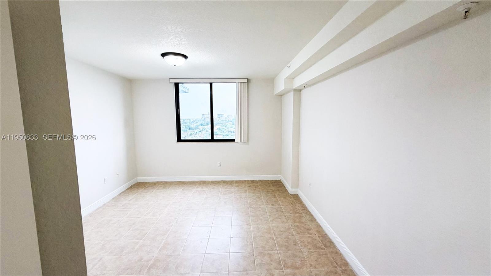 2301 Southwest 27th Avenue, Unit 1200 Miami, FL 33145 - Photo 5 of 24 an empty room with windows