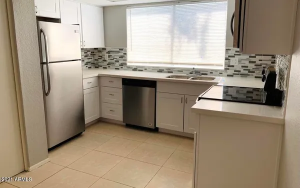a kitchen with a stove a refrigerator and a sink