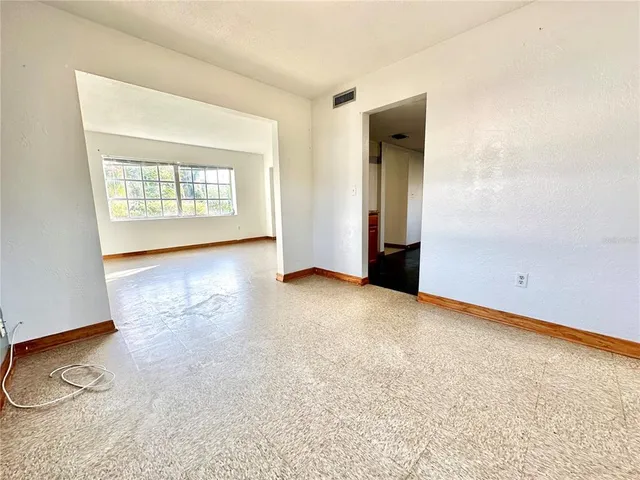 an empty room with a fireplace and painted walls