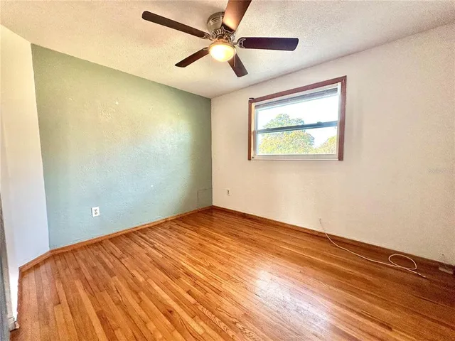 a view of an empty room and wooden floor