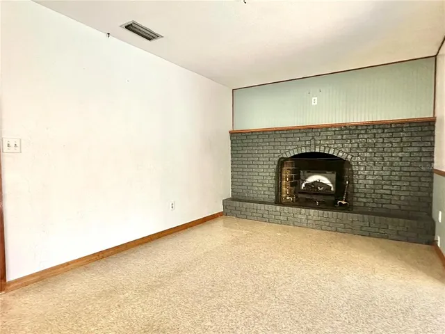 an empty room with a fireplace