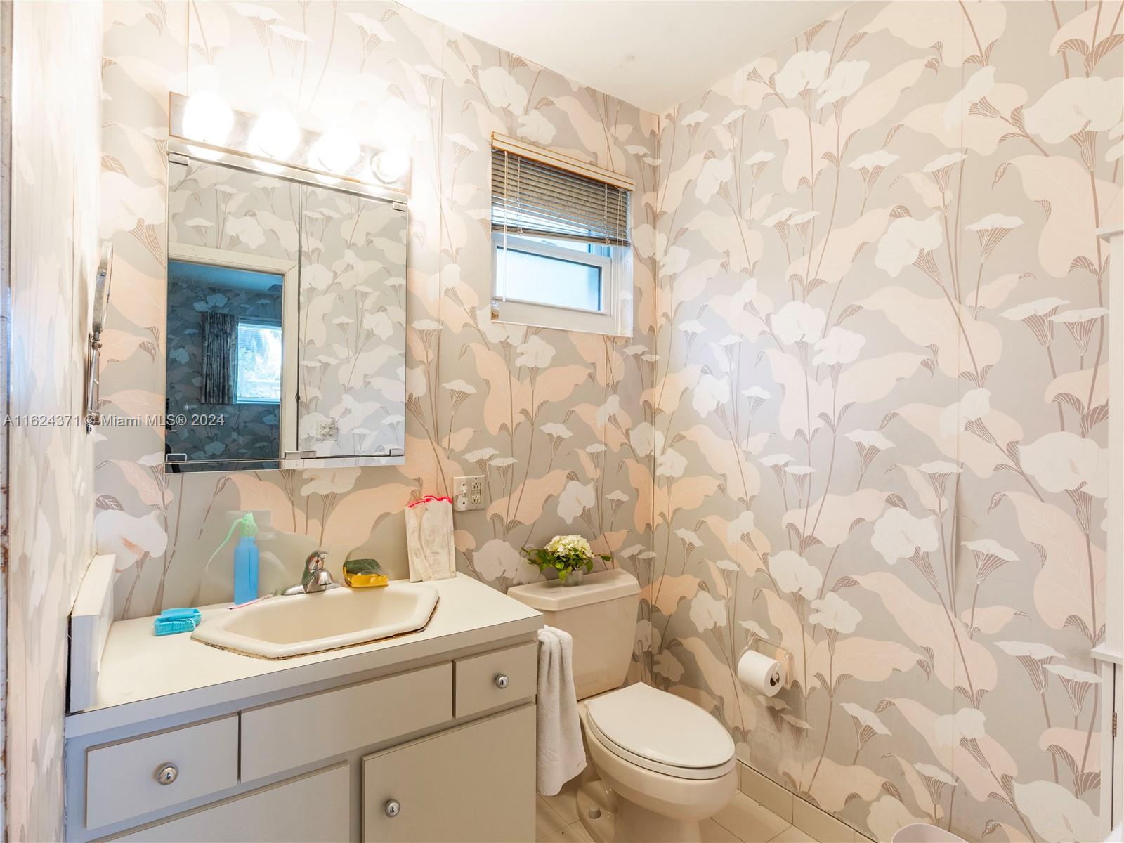 820 Southwest 26th Road Miami, FL 33129 - Photo 8 of 20 a bathroom with a sink a toilet and shower curtain