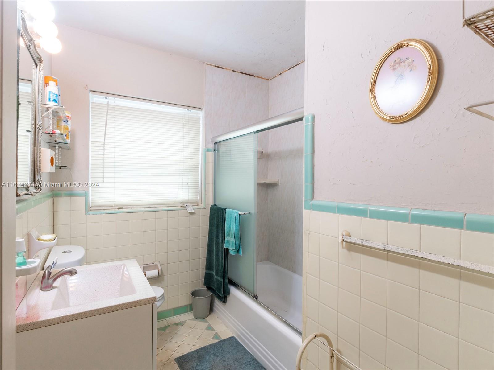 820 Southwest 26th Road Miami, FL 33129 - Photo 10 of 20 a bathroom with a sink a toilet and shower