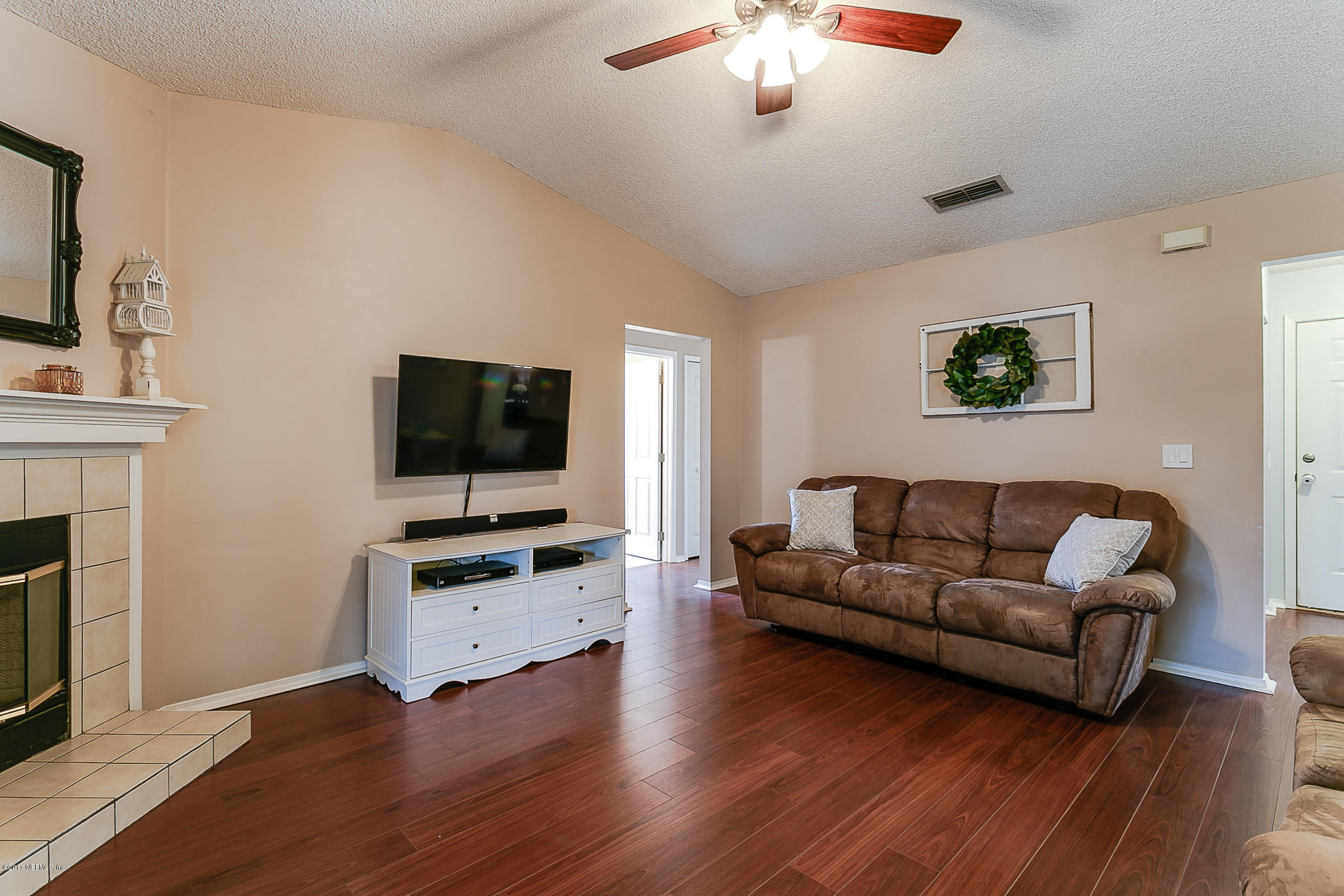 1270 Cutlass Road Orange Park, FL 32065 - Photo 12 of 28 a living room with furniture and a flat screen tv
