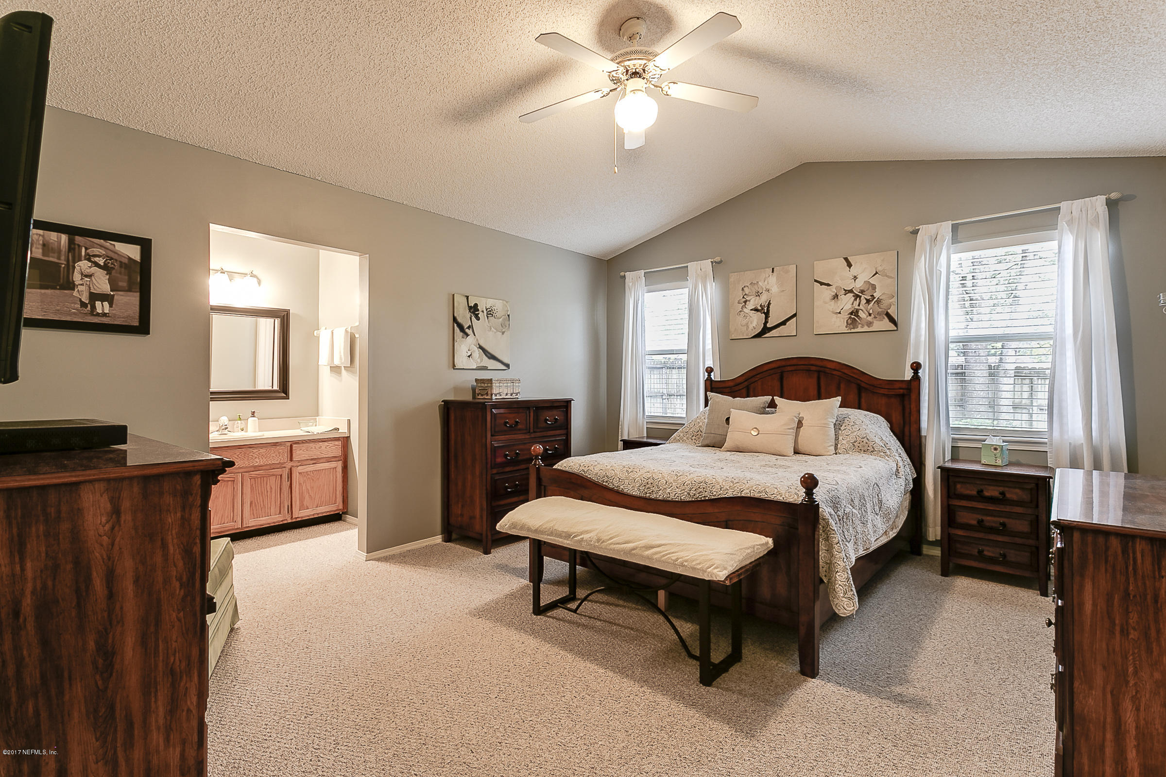 1270 Cutlass Road Orange Park, FL 32065 - Photo 15 of 28 a bedroom with a bed and a chandelier