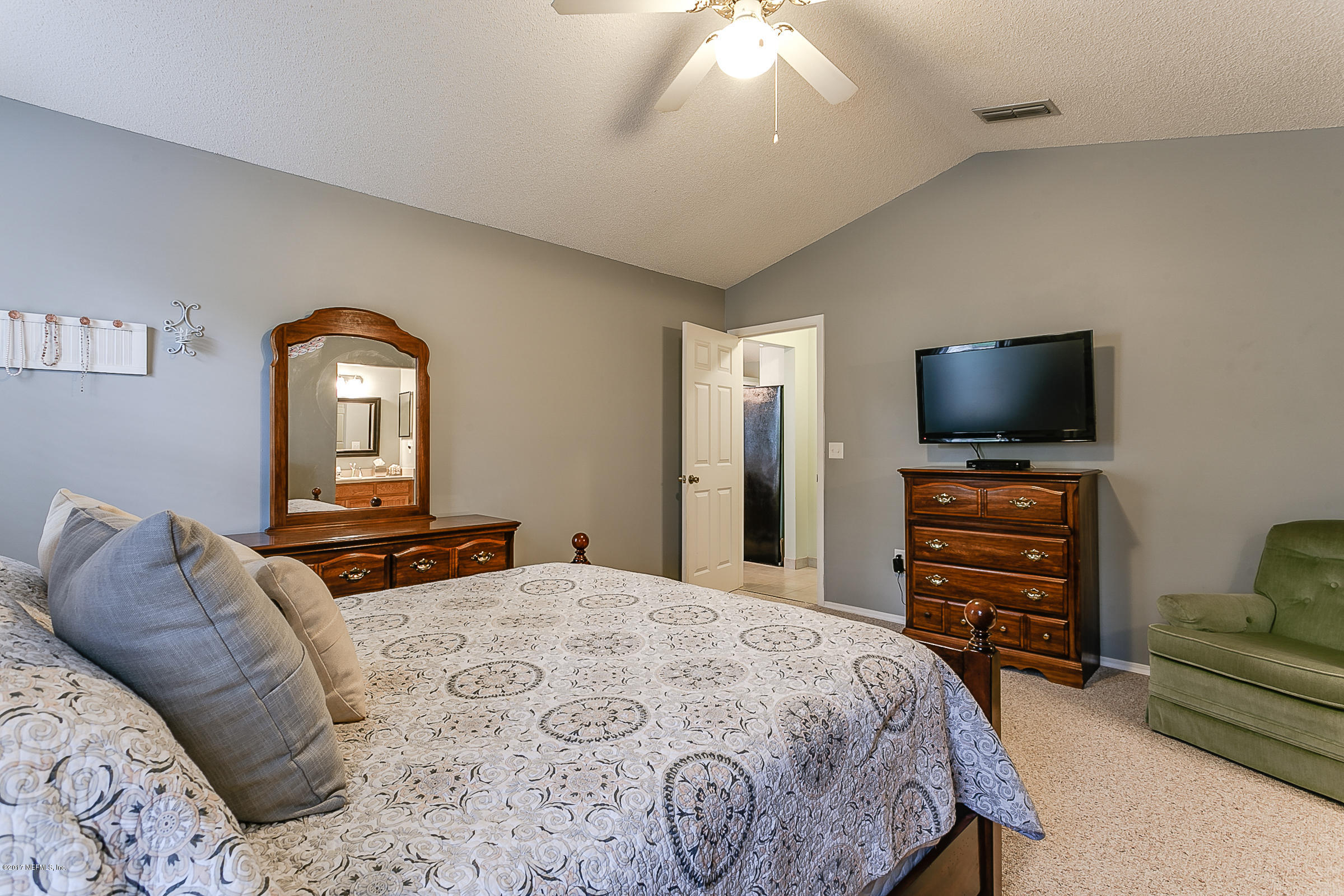1270 Cutlass Road Orange Park, FL 32065 - Photo 16 of 28 a bedroom with a bed and a flat screen tv