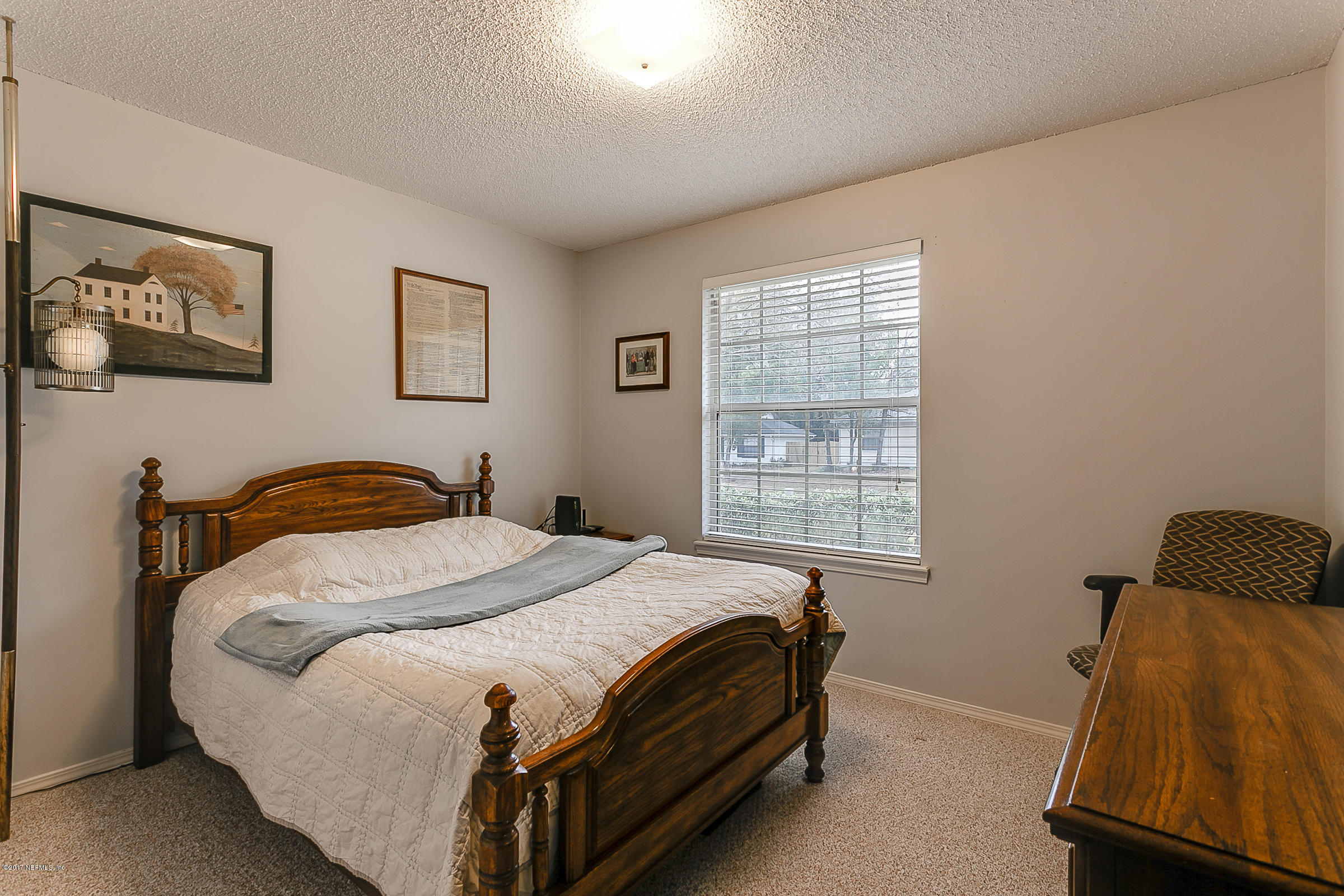 1270 Cutlass Road Orange Park, FL 32065 - Photo 19 of 28 a bed sitting in a bedroom next to a window