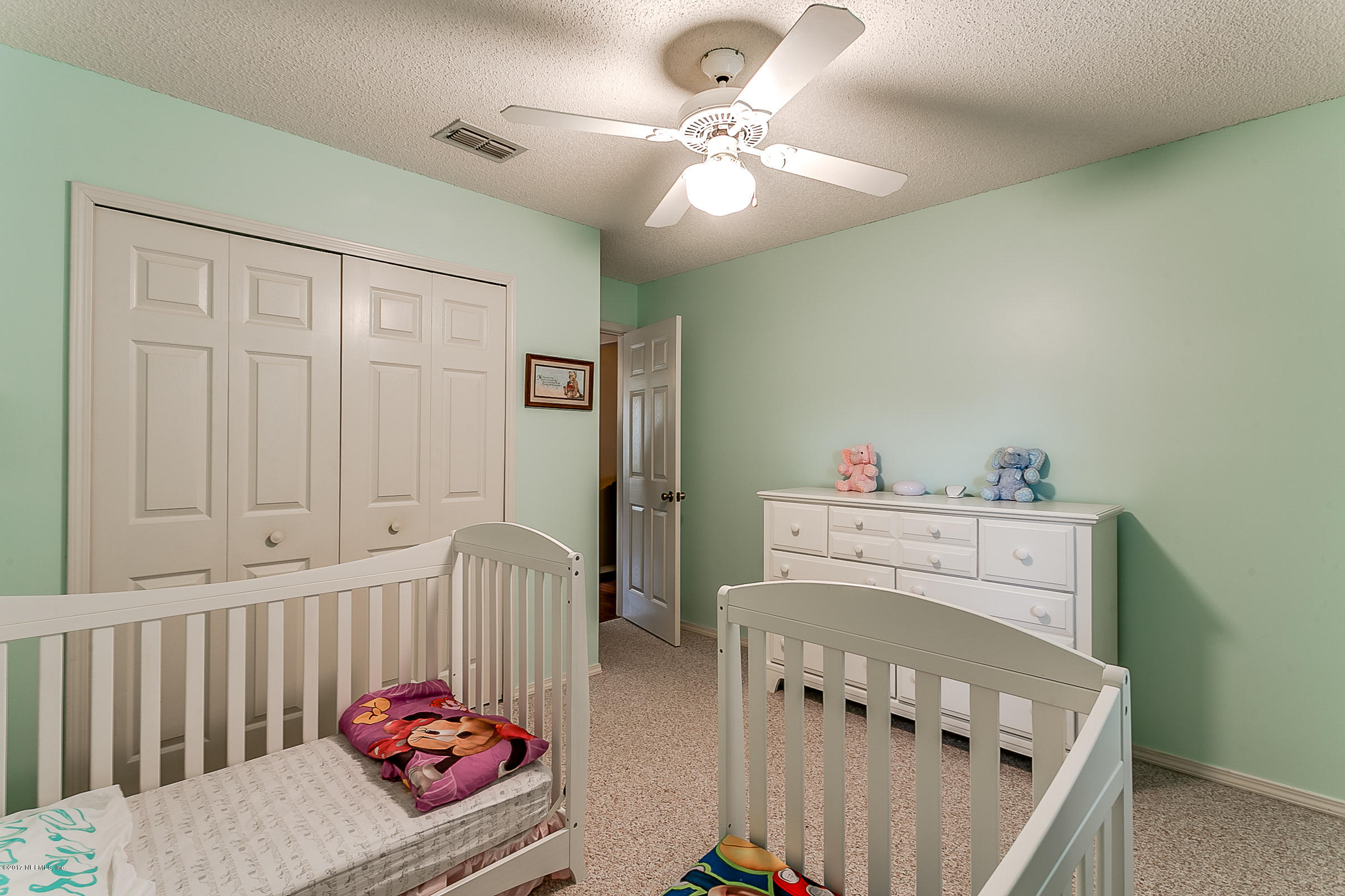 1270 Cutlass Road Orange Park, FL 32065 - Photo 22 of 28 a bedroom with furniture and a baby crib