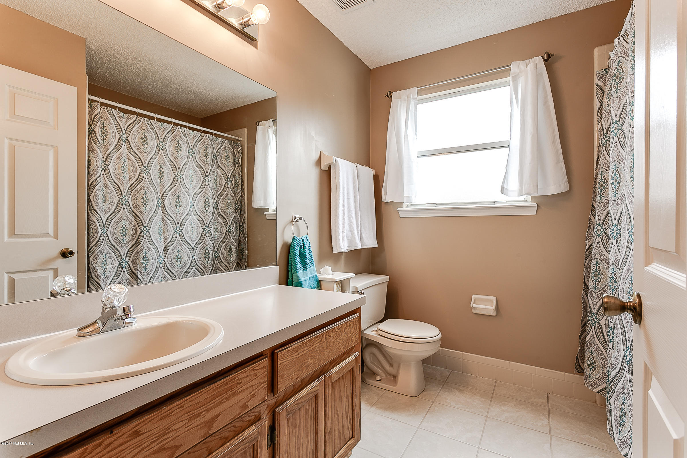 1270 Cutlass Road Orange Park, FL 32065 - Photo 23 of 28 a bathroom with a double vanity sink toilet and a mirror