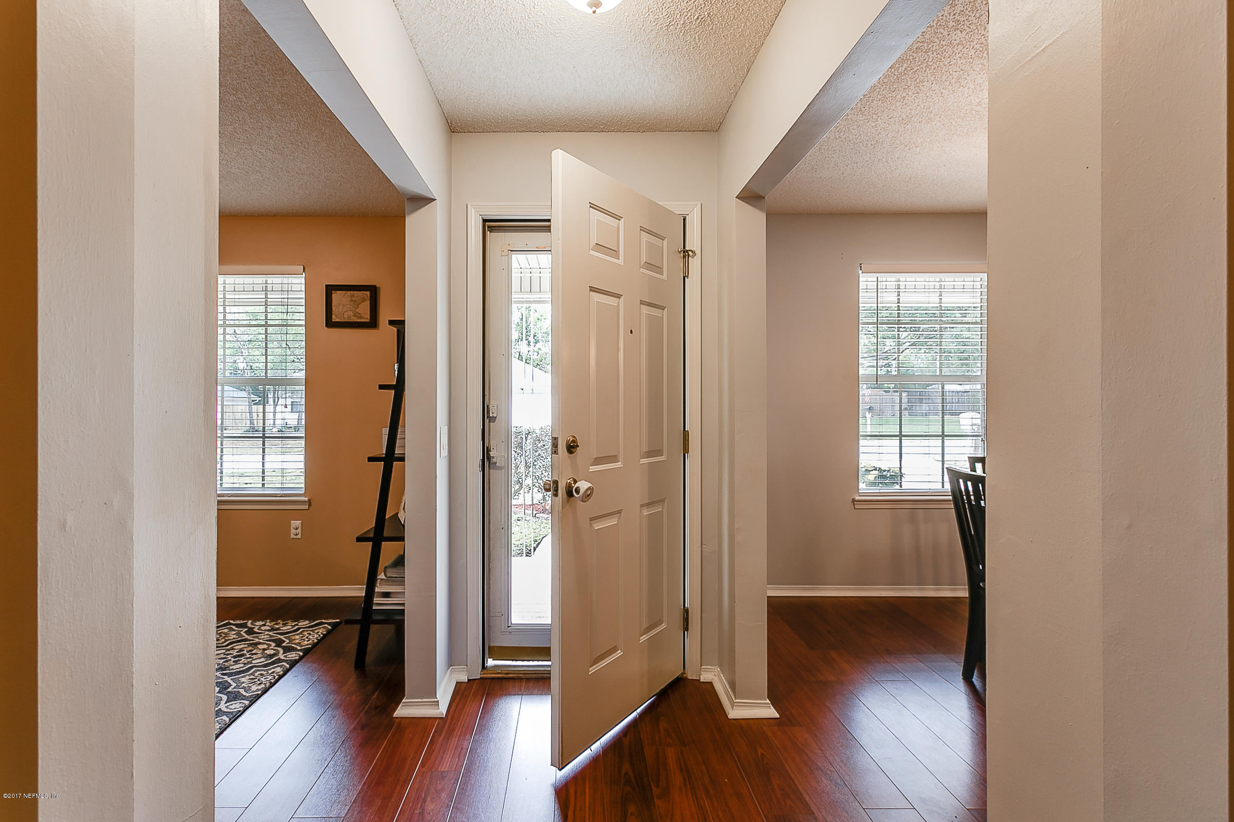 1270 Cutlass Road Orange Park, FL 32065 - Photo 3 of 28 a view of a hallway with wooden floor and a bathroom