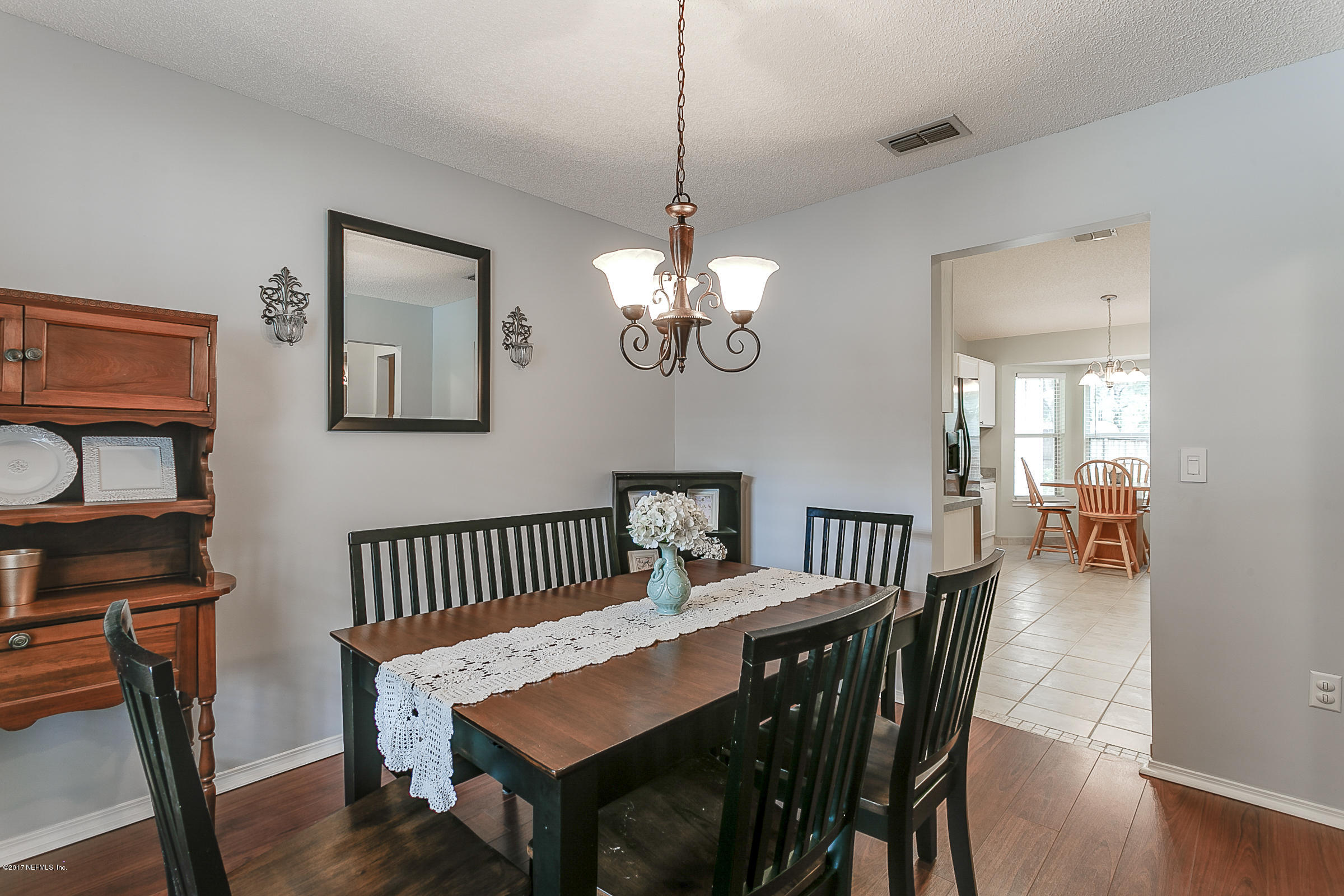 1270 Cutlass Road Orange Park, FL 32065 - Photo 7 of 28 a view of a dining room with furniture and wooden floor