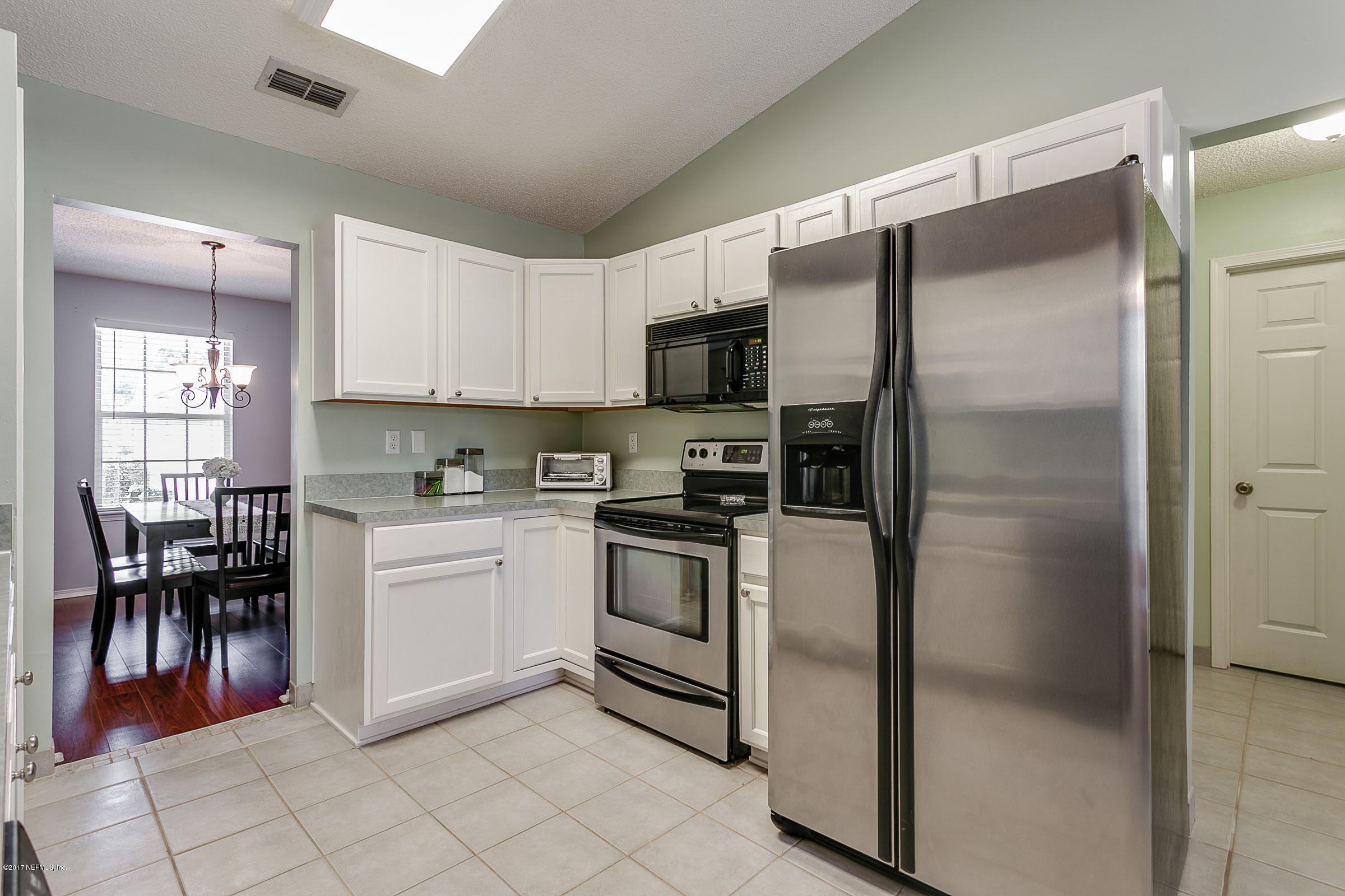 1270 Cutlass Road Orange Park, FL 32065 - Photo 8 of 28 a kitchen with a refrigerator and a stove top oven
