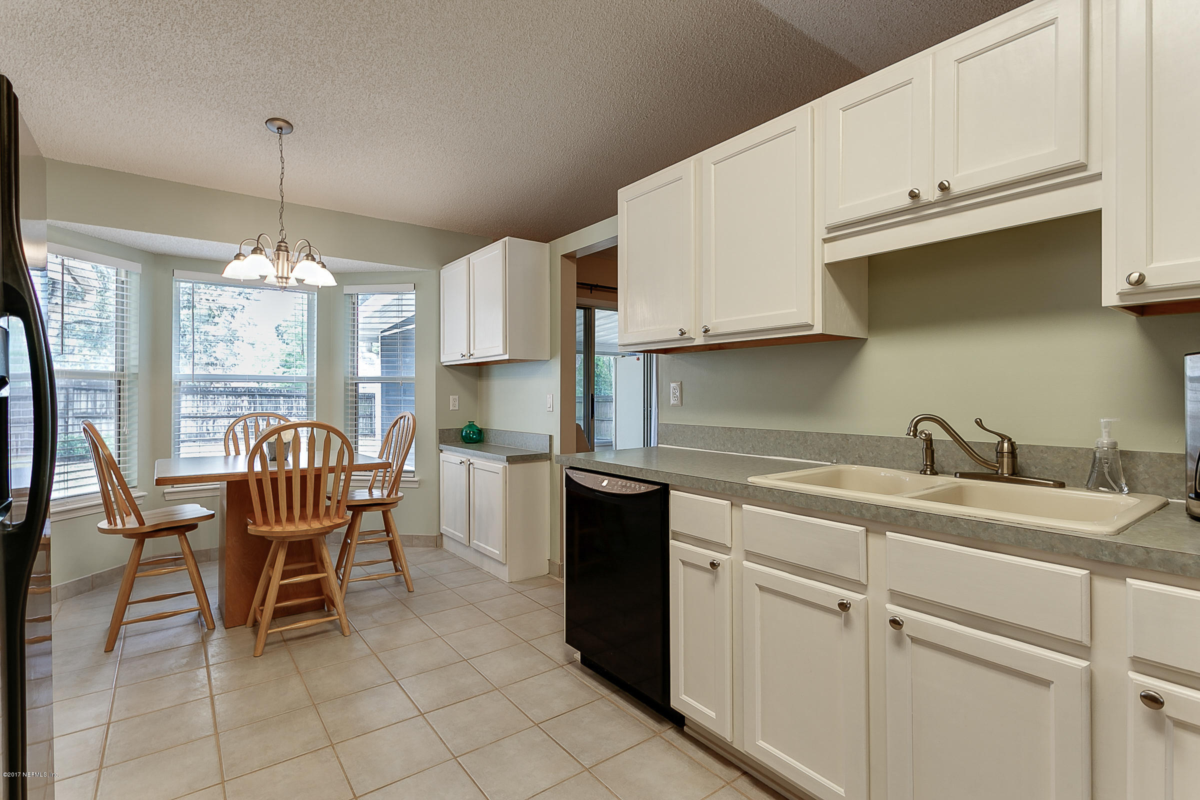 1270 Cutlass Road Orange Park, FL 32065 - Photo 9 of 28 a kitchen with granite countertop cabinets a dining table and chairs