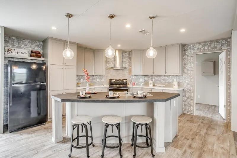 a kitchen with granite countertop a sink and refrigerator