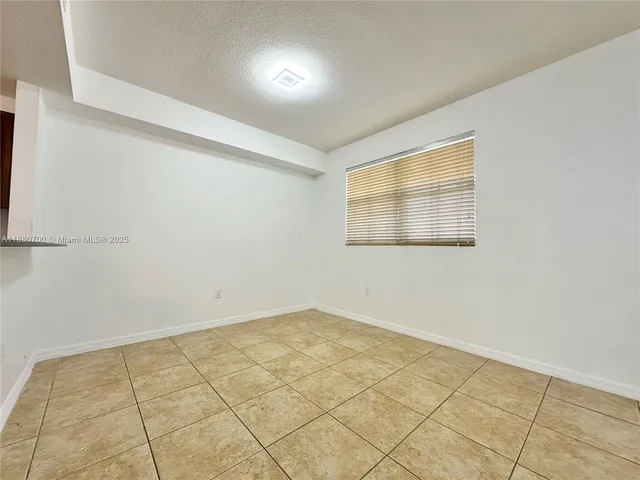 a kitchen with stainless steel appliances granite countertop a refrigerator a stove and a sink with wooden cabinets