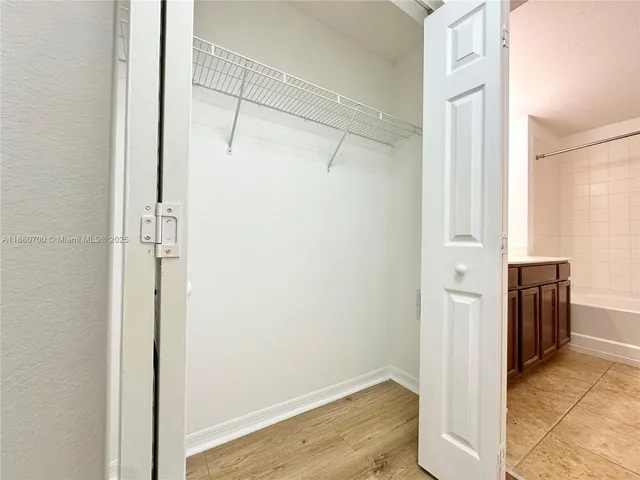 a front view of a house with a garden and trees