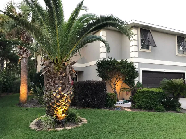 a front view of house with a garden