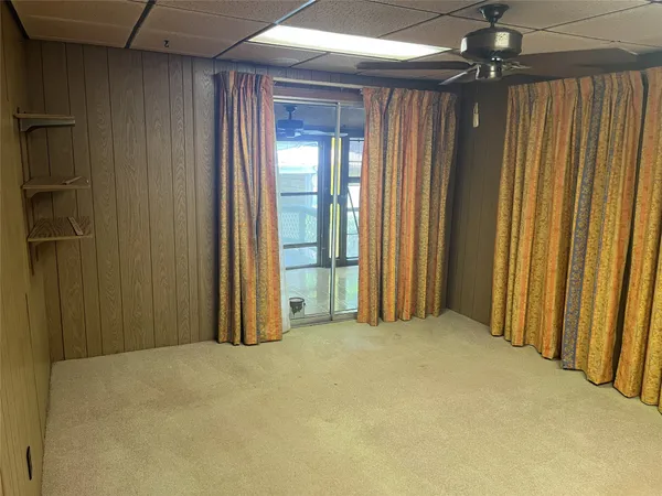 an empty room with closet and windows