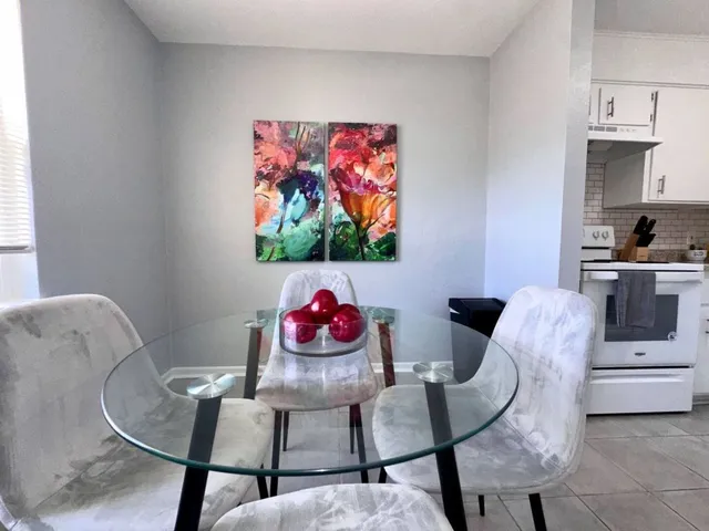 a living room with furniture a rug and white walls